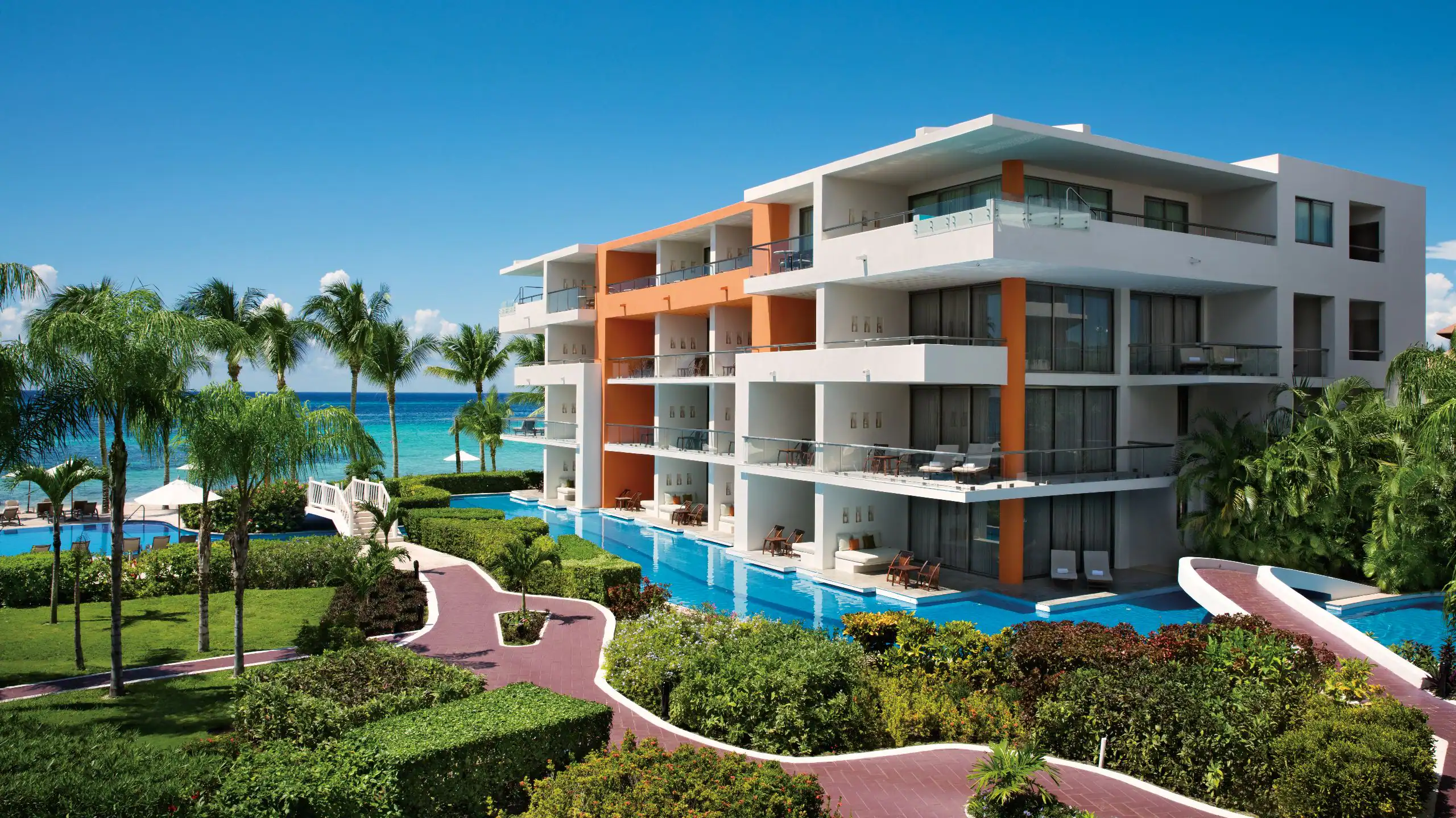 Aura Cozumel Grand Resort adults-only all-inclusive resort with beachfront pools, modern design, and a tranquil atmosphere in Cozumel, Mexico.
