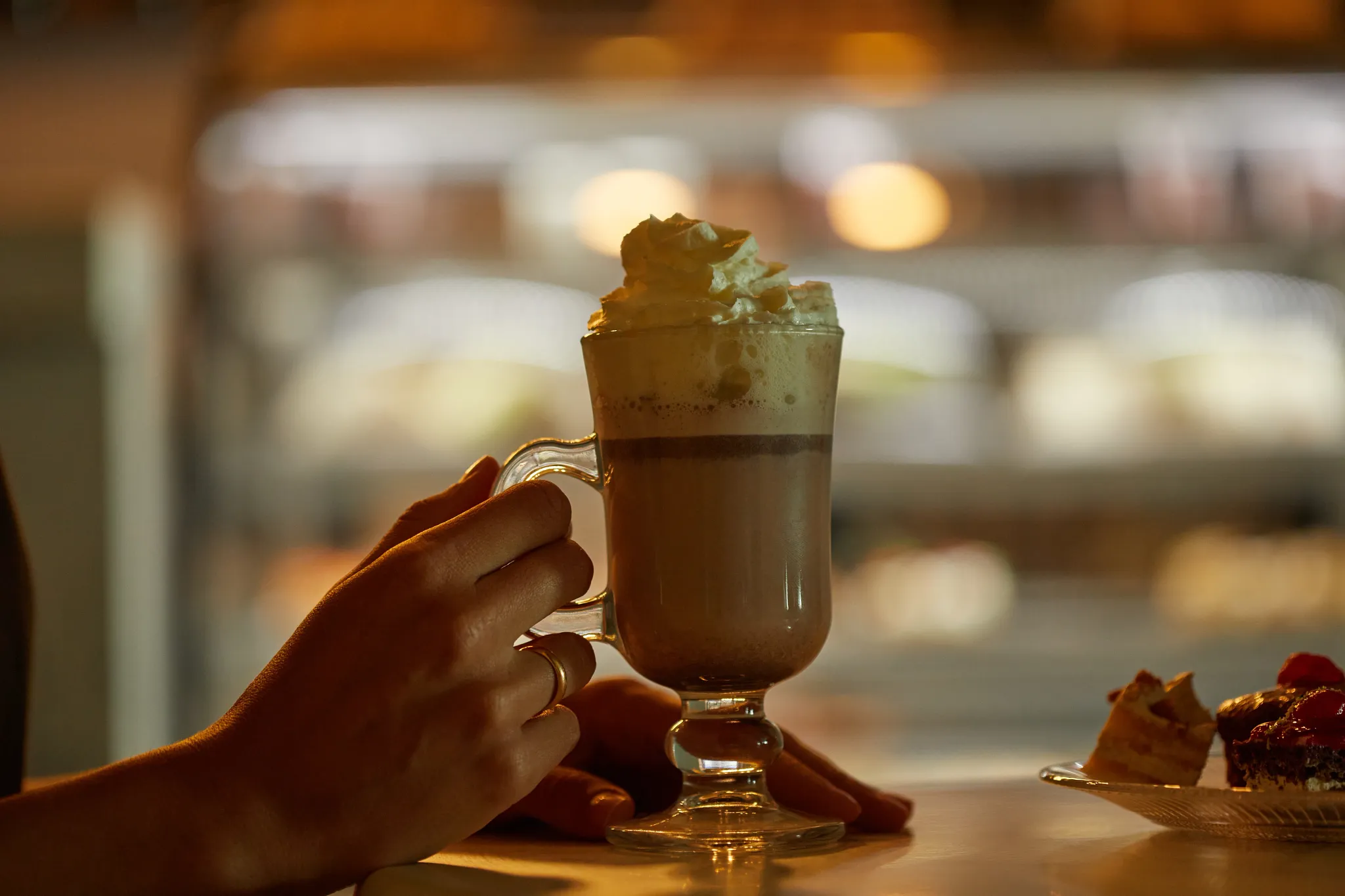 Coco Café at Dreams Cozumel Cape Resort & Spa serving premium coffee drinks, whipped cream-topped latte, pastries, and desserts in a cozy setting.