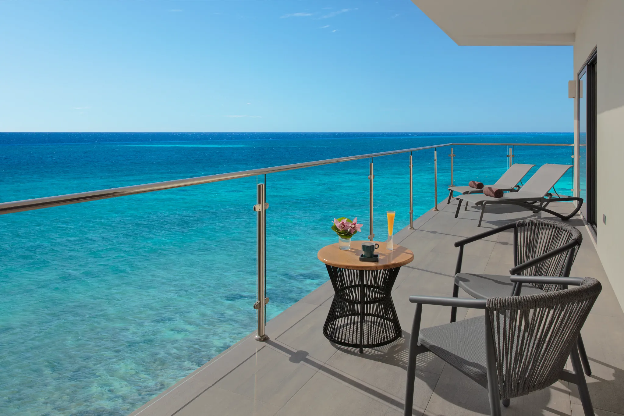 Private ocean-view terrace with lounge chairs at Dreams Cozumel Cape Master Suite.