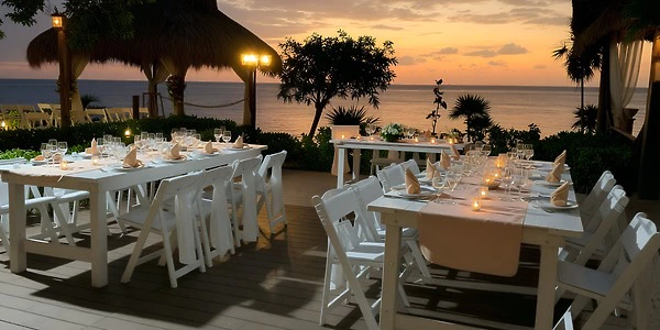 Oceanfront Terrace wedding reception setup at Dreams Cozumel Cape during sunset