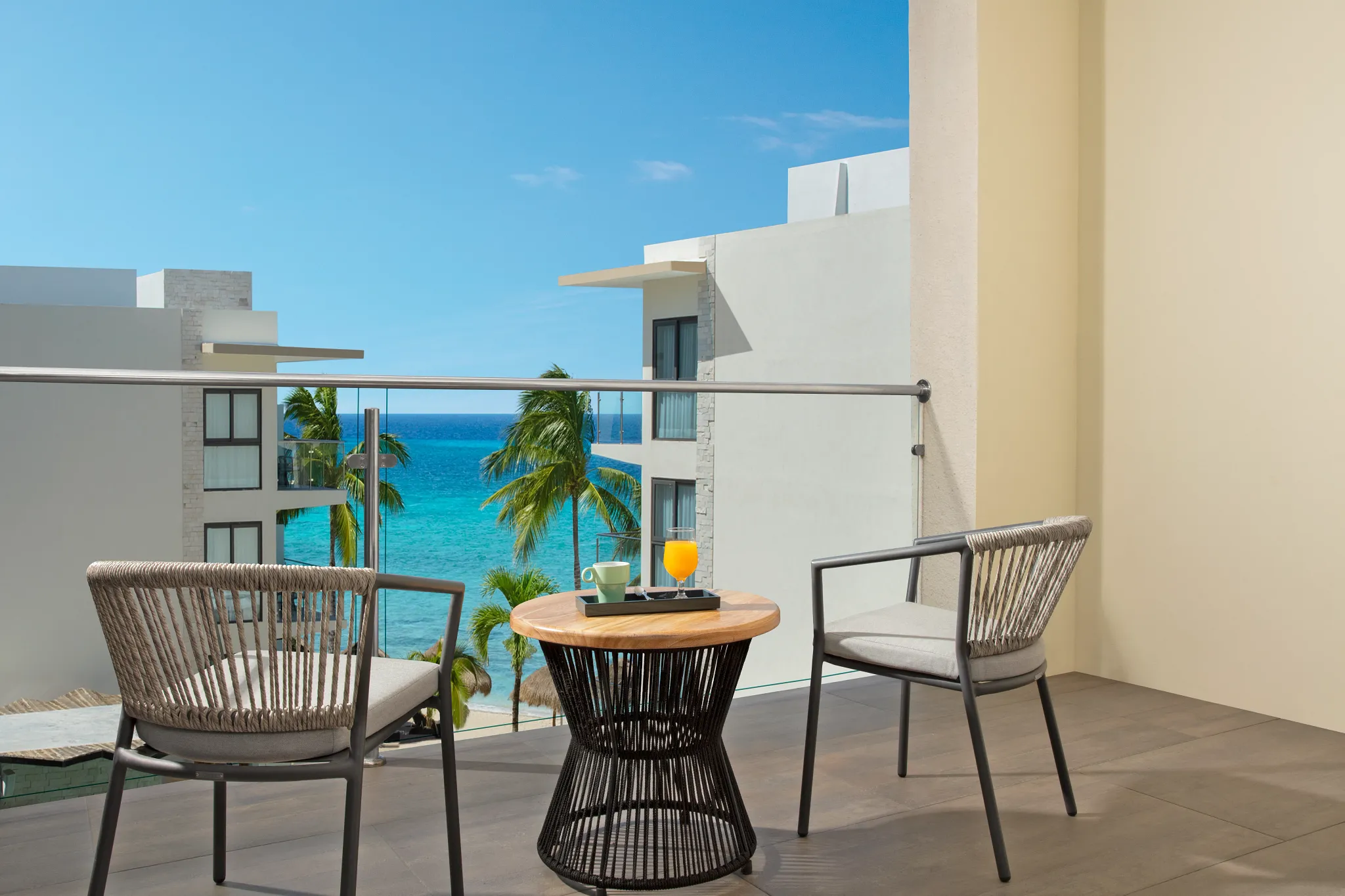 Private furnished balcony with ocean view at Preferred Club Junior Suite Ocean View Dreams Cozumel Cape.