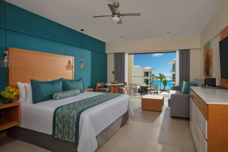 Preferred Club Junior Suite Ocean View with king bed and balcony overlooking the Caribbean at Dreams Cozumel Cape.