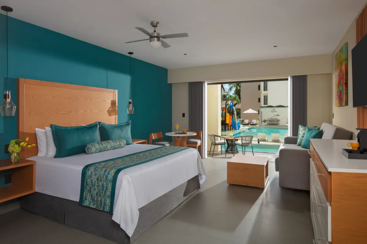 Preferred Club Junior Suite Swim Out Pool View with king bed and terrace at Dreams Cozumel Cape Resort & Spa.