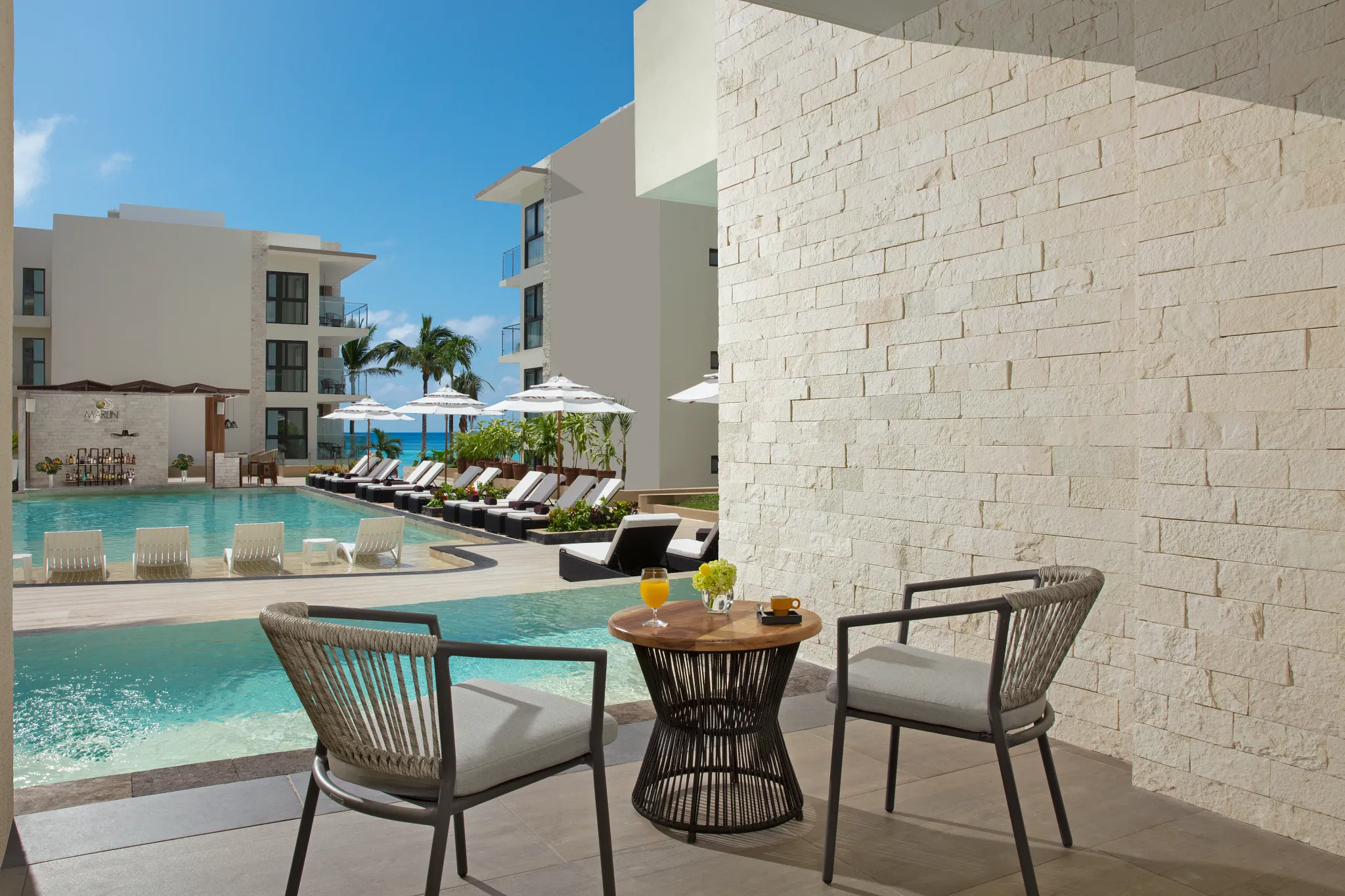 Private swim-out terrace with pool access at Preferred Club Junior Suite Swim Out Pool View Dreams Cozumel Cape.