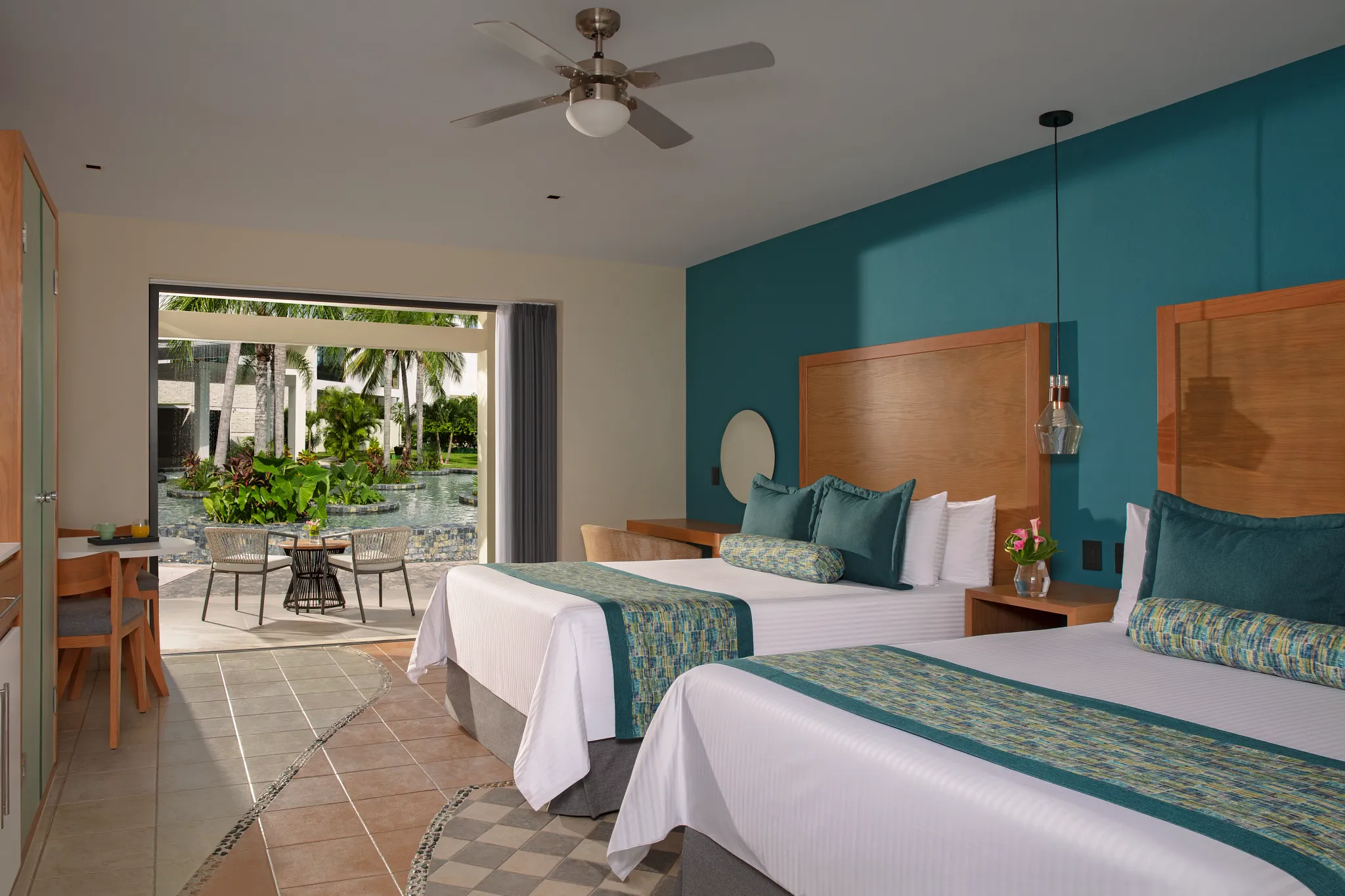 Preferred Club Junior Suite Tropical View with two queen beds and garden terrace at Dreams Cozumel Cape Resort & Spa.