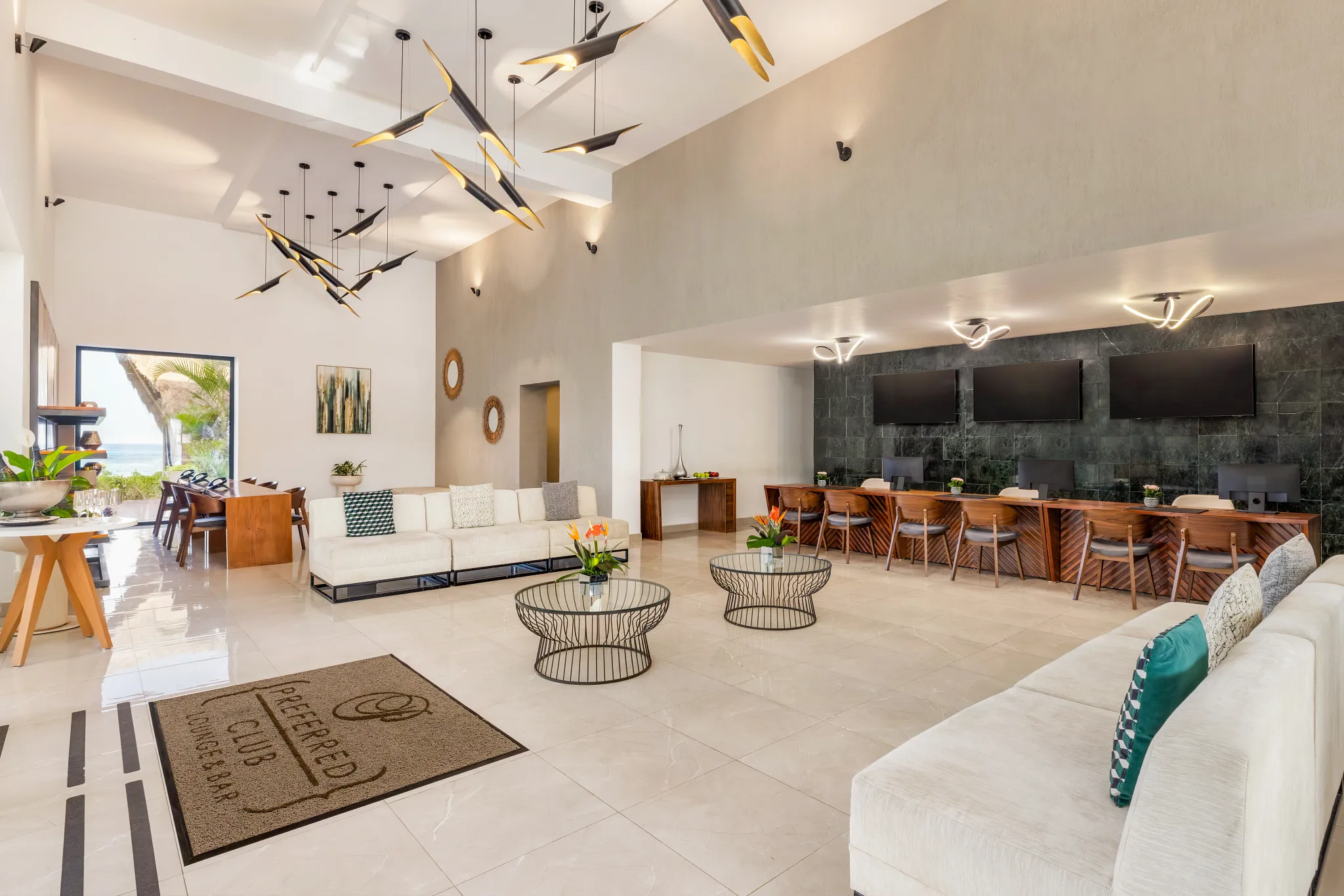 Preferred Club lounge seating area at Dreams Cozumel Cape Resort & Spa with concierge desk and premium amenities.