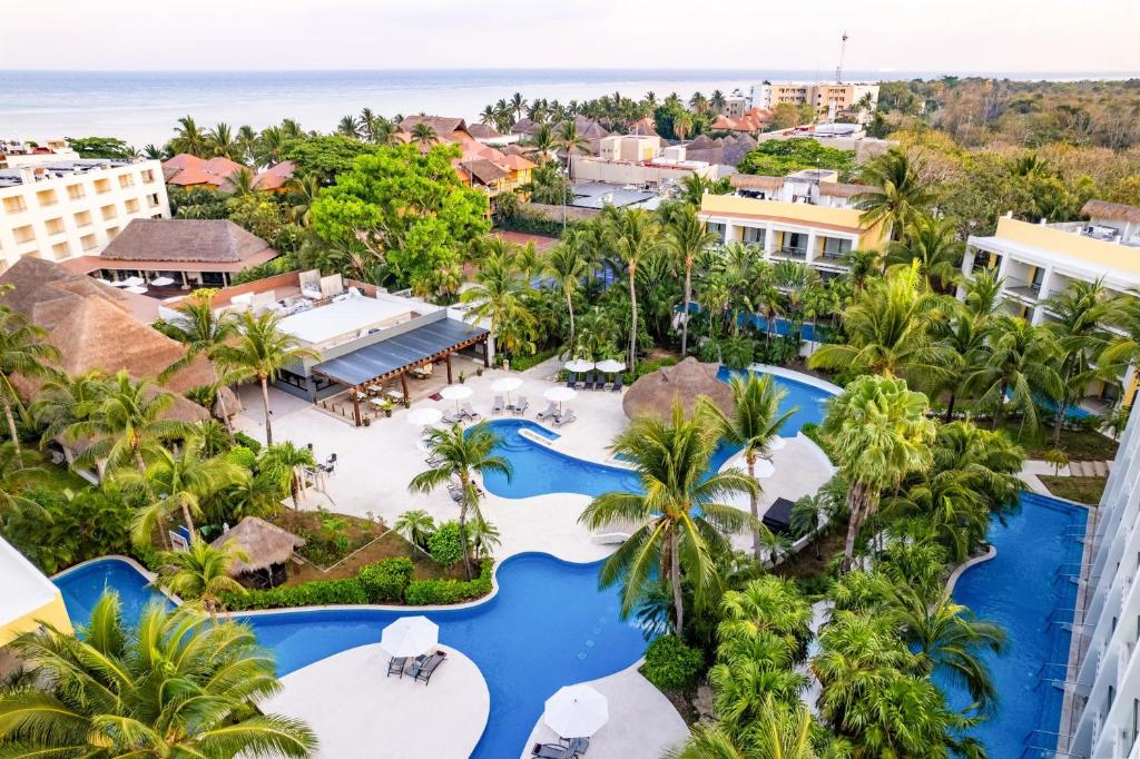 Secrets Aura Cozumel adults-only all-inclusive resort with oceanfront infinity pool, romantic suites, and Caribbean Sea views.